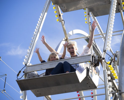 Family-friendly activities including a ferris wheel took over a parking lot for a corporation's outdoor festival.