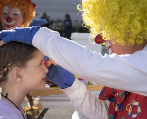 Children enjoyed face painting along with other activities at a family-friendly outdoor festival.